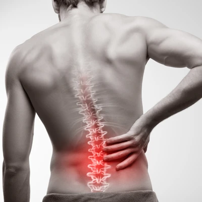 A man with back pain shown with red highlighting