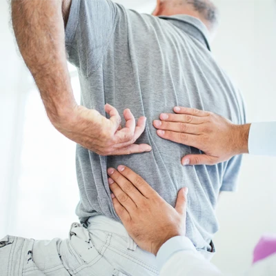 A patient with back pain being examined by a doctor